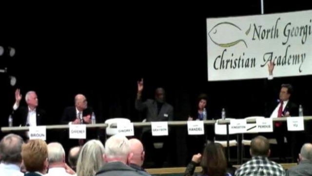 GOP candidate for U.S. Senate in Georgia indicates his support during a tea party sponsored candidate forum.