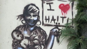 PHOTO The walls Rosembert tags show images of children with Santa Claus and a snowman, and a young wheelchair-bound child thrusting a bleeding Haitian flag into the air.
