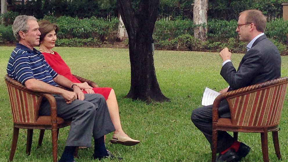 PHOTO: George W. Bush and wife Laura speak with jon Karl