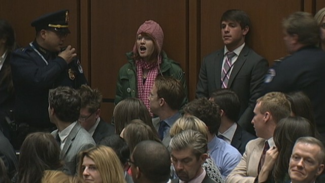 VIDEO: Woman shouting about the Middle East is escorted from room during senators testimony.