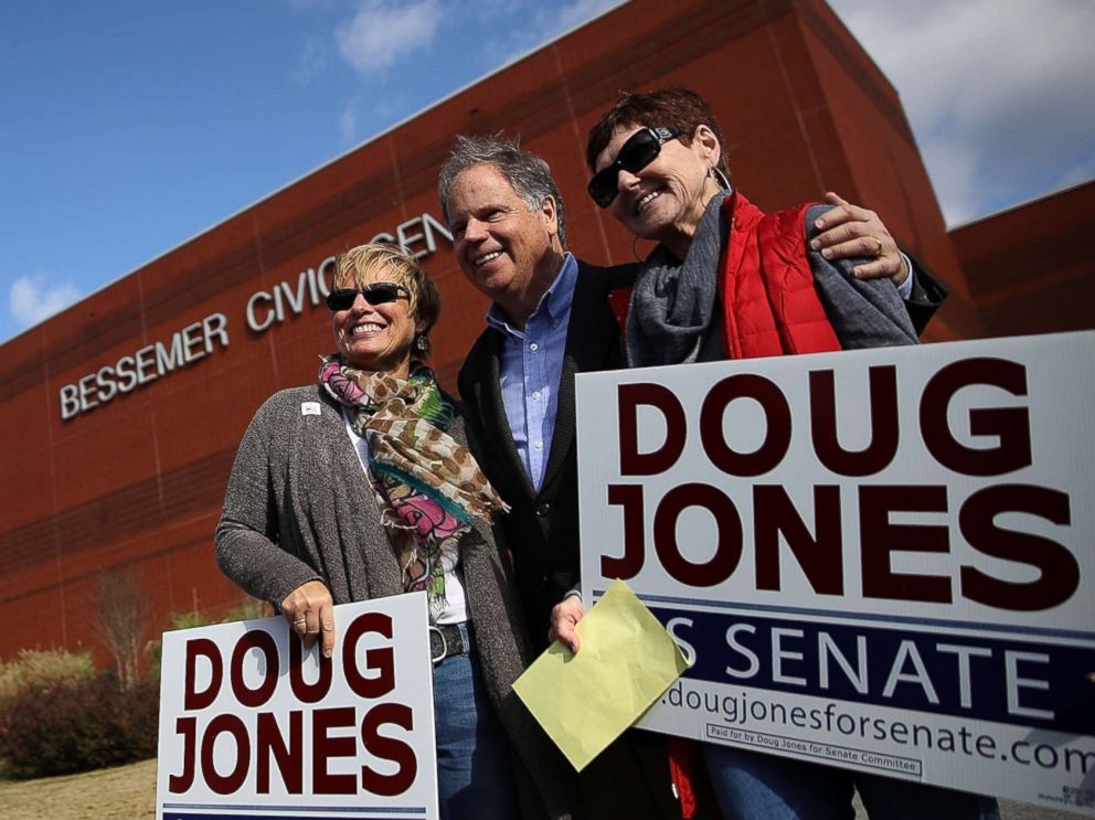 PHOTO: Democratic senatorial candidate Doug Jones takes a picture with voters outside of a polling station at the Bessemer Civic Center on Dec. 12, 2017 in Bessemer, Ala.