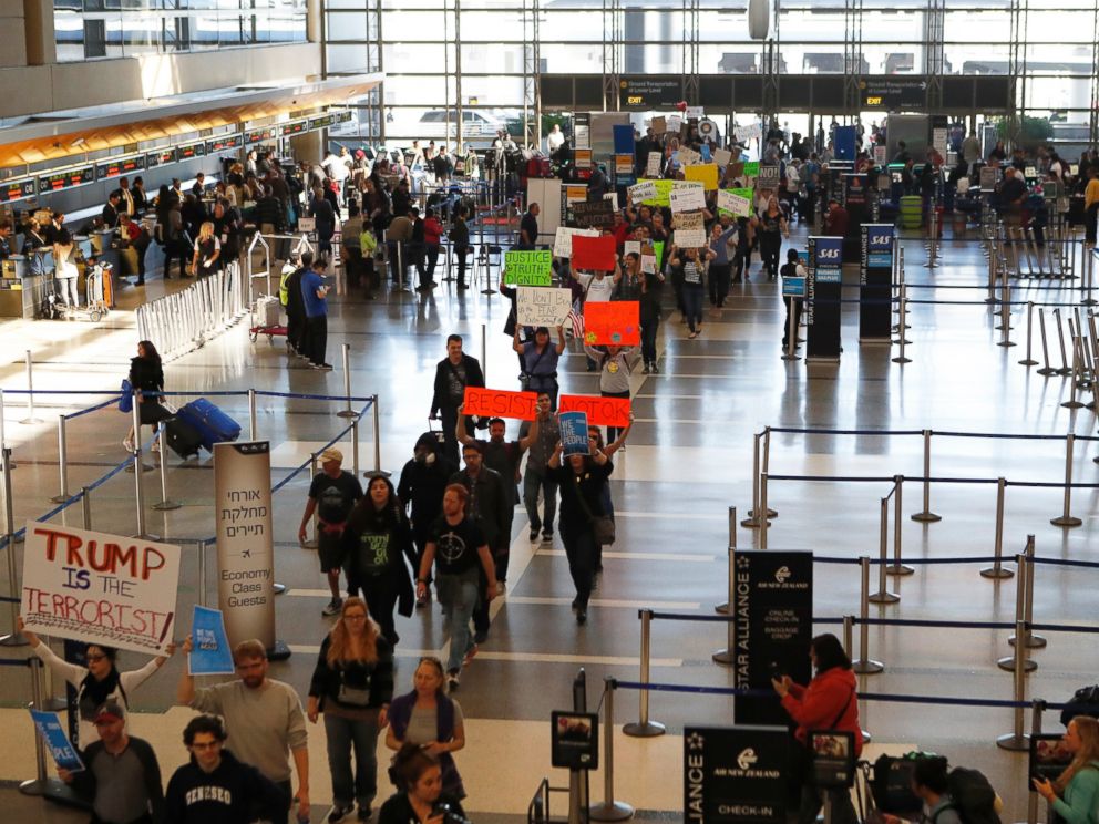PHOTO: Demonstrators march through Tom Bradley International Terminal as protests against President Donald Trumps executive order banning travel from seven Muslim-majority countries continue at Los Angeles International Airport, Jan. 29, 2017.