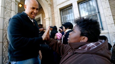 PHOTO: In this Nov. 9, 2012 file photo, Newark Mayor Cory Booker, left, greets 13-year-old Blonbzell Taylor outside of Clinton Hill Community Resource Center; on Nov. 29, 2012, Booker said he will live on food stamps for a week starting on Dec. 4, 2012, h
