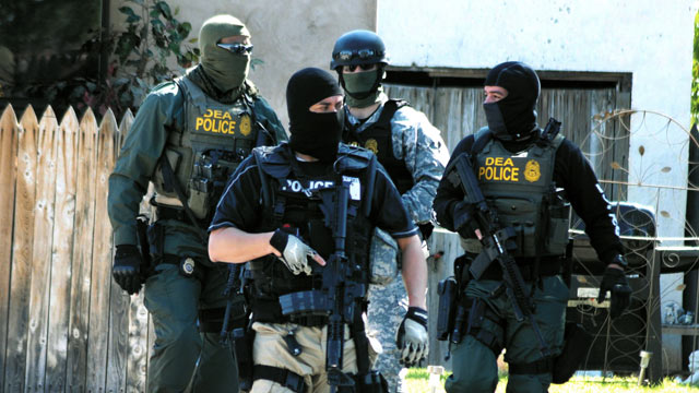 PHOTO: Drug Enforcement Administration Special Agents leave a house, Sept. 23, 2011, in Roswell, N.M., as part of an investigation that included the arrest of dozens of suspected drug traffickers.