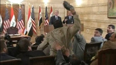 PHOTO: A man, center, throws a shoe at US President George W. Bush, background left, during a news conference with Iraq Prime Minister in Baghdad, Iraq, Dec. 14, 2008