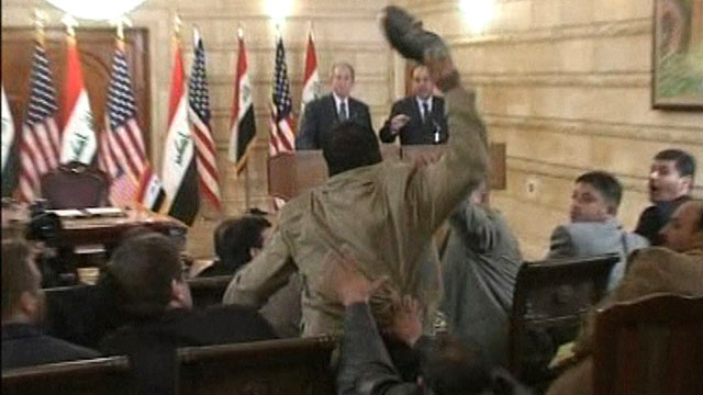 PHOTO: A man, center, throws a shoe at US President George W. Bush, background left, during a news conference with Iraq Prime Minister in Baghdad, Iraq, Dec. 14, 2008