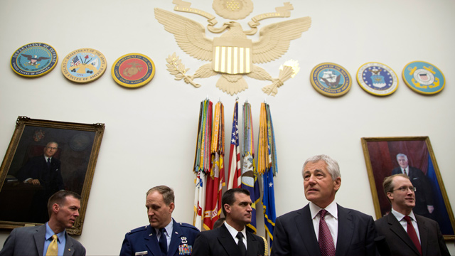 PHOTO: Defense Secretary Chuck Hagel, second from right, stands with staff as he arrives on Capitol Hill in Washington, April 11, 2013, to testify before the House Armed Services Committee hearing on the Defense Departments fiscal 2014 National Defense A