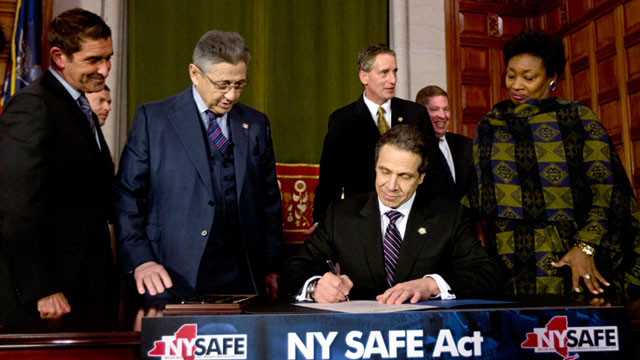 PHOTO: New York Gov. Andrew Cuomo signs New Yorks Secure Ammunition and Firearms Enforcement Act into law during a ceremony in the Red Room at the Capitol, Jan. 15, 2013, in Albany, N.Y.