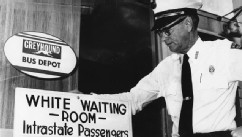 PHOTO: Police Chief George H. Guy poses beside the "White waiting room" sign posted outside the Greyhound bus terminal in McComb, Mi., on Nov. 2, 1961.