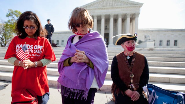 PHOTO: Protestors pray in front the Court in Washington, March 28, 2012, as the court concludes three days of hearing arguments on the constitutionality of President Barack Obama's health care overhaul.