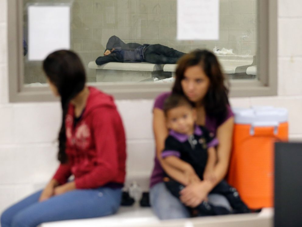 Detainees wait at a U.S. Customs and Border Protection processing facility, June 18, 2014, in Brownsville, Texas.