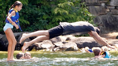 PHOTO: Republican presidential candidate, former Mass. Gov. Mitt Romney dives into Lake Winnipesaukee at Winter Harbor in Wolfeboro, N.H., July 6, 2012.