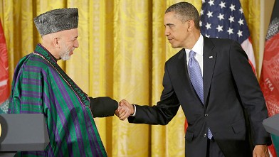 President Barack Obama shakes hands with Afghan President Hamid Karzai at the conclusion of their joint news conference in the East Room of the White House in Washington, Jan. 11, 2013.