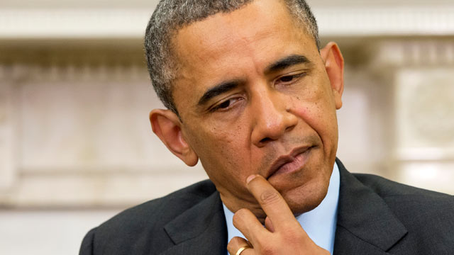 PHOTO: President Barack Obama rubs his face as Myanmars President Thein Sein speaks during their meeting in the Oval Office of the White House in Washington, May 20, 2013.