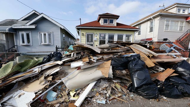 PHOTO: The contents of residents' once-flooded homes still lie in the streets of a neighborhood in the Rockaways section of New York on Christmas Day, Dec. 25, 2012, nearly two months after storm surge from Jamaica Bay during Superstorm Sandy flooded the 