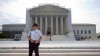 A police officer keeps watch outside the Supreme Court in Washington, June 17, 2013.