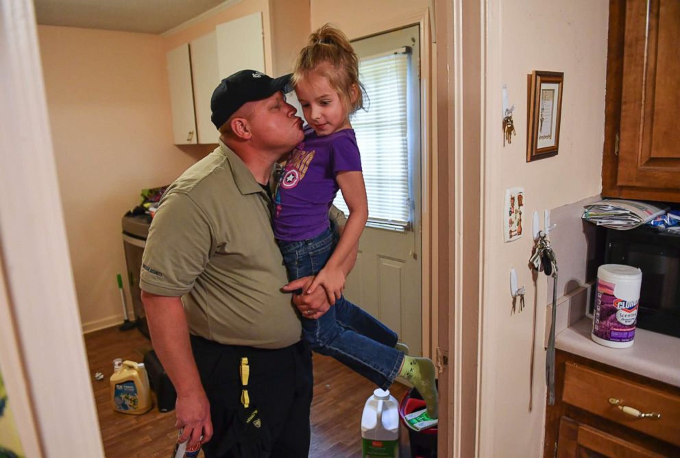 PHOTO: Ava Olsen, 7, who was on the playground during the Townville Elementary shooting, gets a hug and kiss from her dad, David, after he arrived home from work on May 1, 2017 in Townville, S.C.