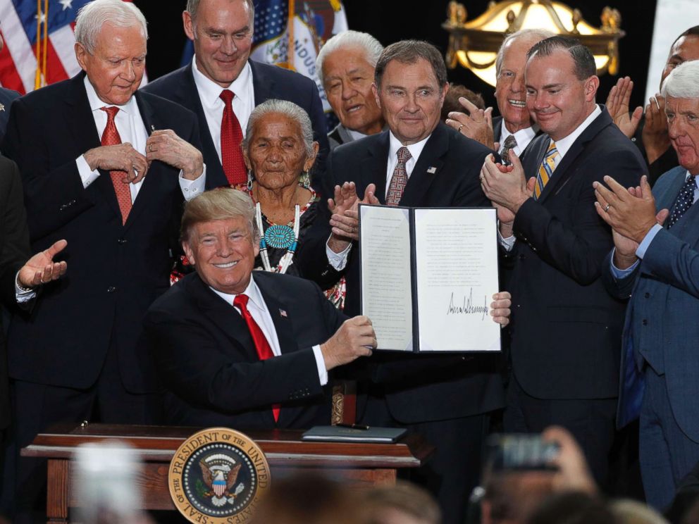 PHOTO: With Utah officials surrounding him, President Donald Trump shows an executive order he signed reducing the Grand Staircase-Escalante National Monument at the Rotunda of the Utah State Capitol, Dec. 4, 2017, in Salt Lake City, Utah.