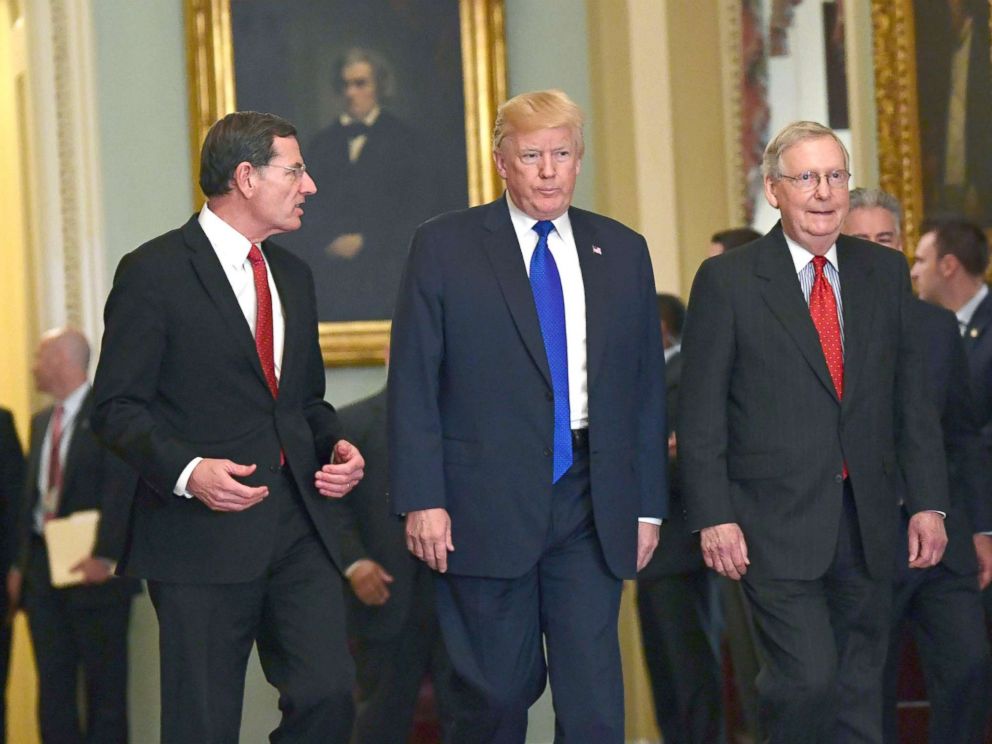 PHOTO: President Donald Trump, walks with Sen. John Barrasso, left, and Senate Majority Leader Mitch McConnell, right, as he arrives on Capitol Hill in Washington, Nov. 28, 2017.