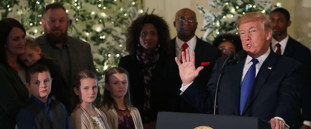PHOTO: President Donald Trump speaks while flanked by families he said would benefit from tax reform, in the White House on Dec. 13, 2017 in Washington.