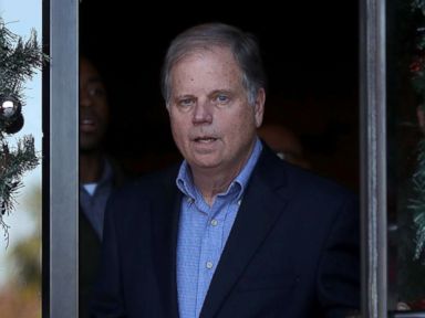 PHOTO: Democratic Senatorial candidate Doug Jones walks out of a campaign stop at Marthas Place, Dec. 11, 2017, in Montgomery, Alabama.
