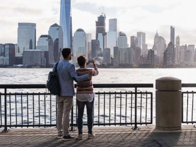 PHOTO: A couple stands looking at Manhattan.