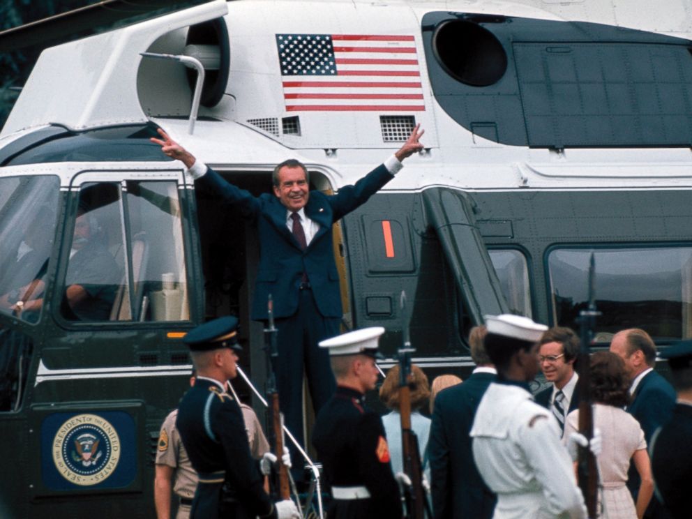 PHOTO: President Richard Nixon raises his hands with his trademark V sign in the doorway of a helicopter after leaving the White House following his resignation over the Watergate scandal, Aug. 9, 1974.