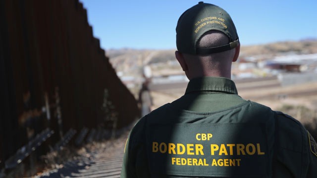PHOTO: A U.S. Border Patrol agent looks along a section of the recently-constructed fence at the U.S.-Mexico border on February 26, 2013 in Nogales, Arizona.