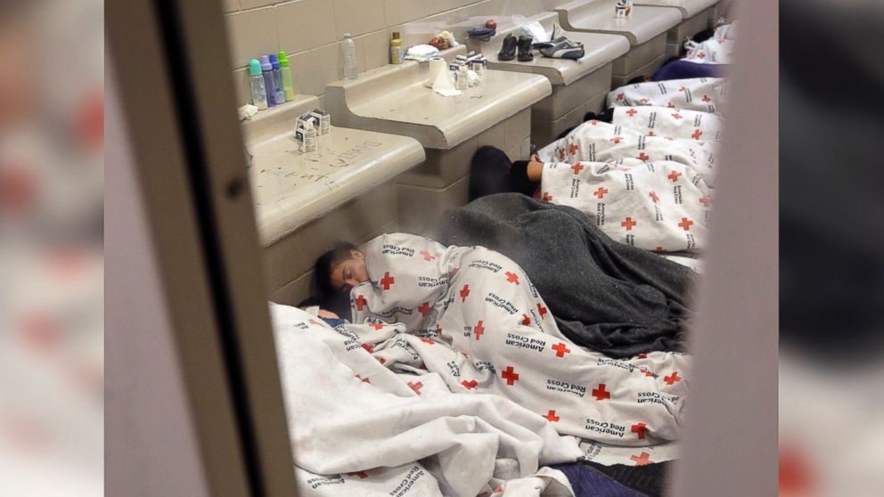 PHOTO: Sleeping detainees are seen through the window of holding cell at a U.S. Customs and Border Protection processing facility, on June 18, 2014, in Brownsville, Texas.