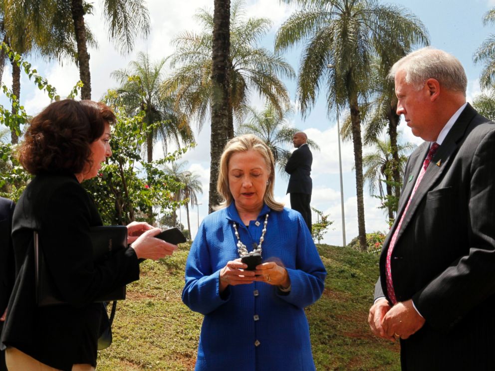 PHOTO: Secretary of State Hillary Rodham Clinton writes on her cell phone with Roberta S. Jacobson, left, and Thomas Shannon in Brasilia, Brazil, April 17, 2012. 