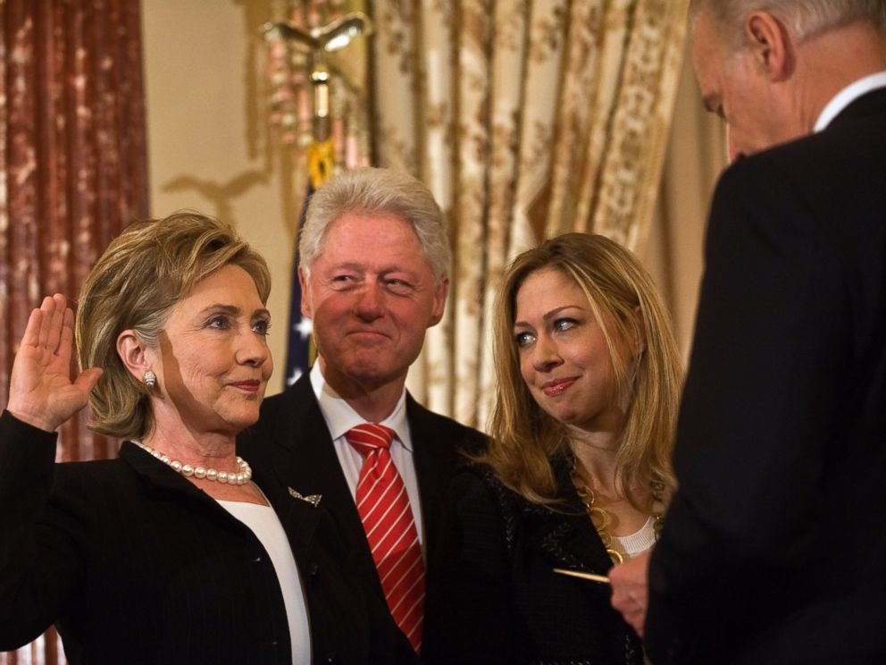 PHOTO: US Secretary of State Hillary Clinton is ceremonially sworn in by Vice President Joe Biden as her husband former president Bill Clinton and daughter Chelsea look on at the State Department in Washington, Feb. 2, 2009. 