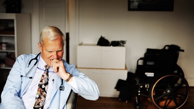 PHOTO: With approximately 65 percent of his patients insured by Medicare, rural Doctor Emery Lewis, considers a question from an older patient during an examination, in Reedville, Virginia on December 12, 2011.