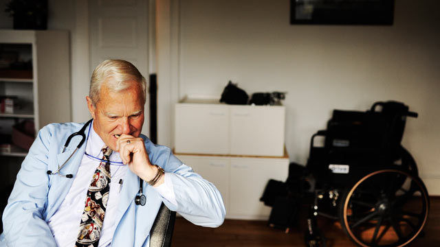 PHOTO: With approximately 65 percent of his patients insured by Medicare, rural Doctor Emery Lewis, considers a question from an older patient during an examination, in Reedville, Virginia on December 12, 2011.