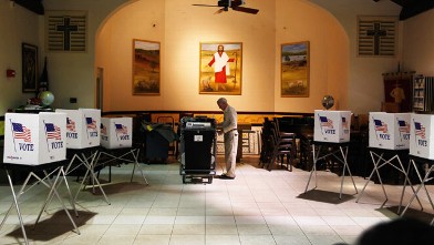 PHOTO: Ray Roy sets up a polling station in preparation for voters on primary day January 31, 2012 in Tampa, Florida.