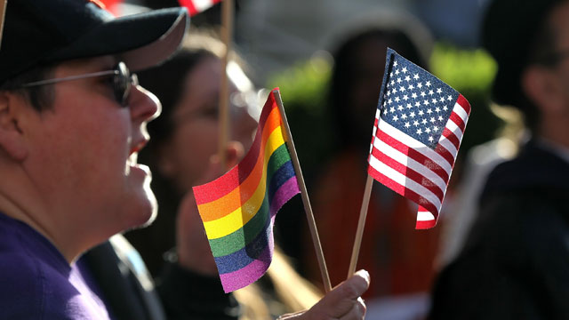 PHOTO: An opponent of Prop 8 holds an American flag and gay pride flag during a demonstration outside of the Ninth Circuit Court of Appeals in this Dec. 6, 2010 file photo in San Francisco, Cali.