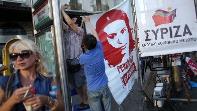 PHOTO: Supporters of the Syriza party erect a banner before a rally ahead of Sunday's general election, June 14, 2012 in Athens, Greece.