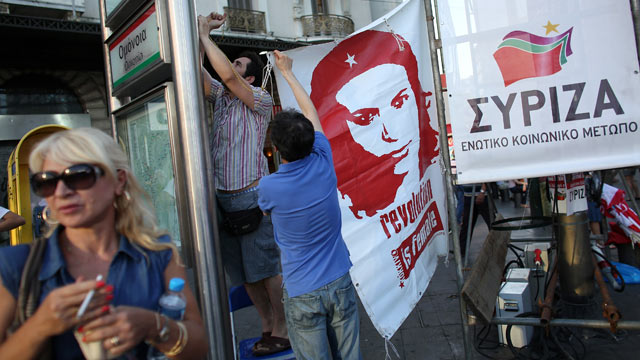 PHOTO: Supporters of the Syriza party erect a banner before a rally ahead of Sunday's general election, June 14, 2012 in Athens, Greece.