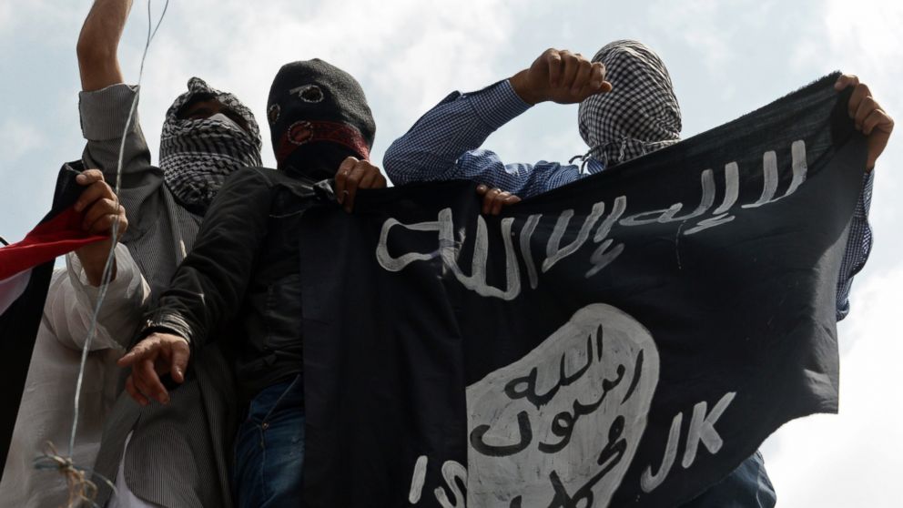 PHOTO: Kashmiri demonstrators hold up a flag of the Islamic State of Iraq and the Levant (ISIL) during a demonstration against Israeli military operations in Gaza, in downtown Srinagar, July 18, 2014. 