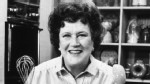 PHOTO: American chef Julia Child stands in front of a countertop, holding a whisk and a ladle, on the set of her television series, "The French Chef".