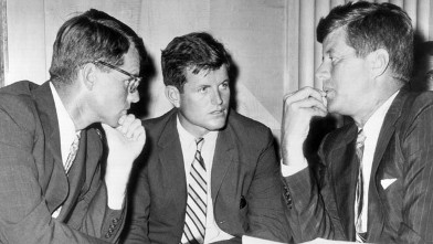PHOTO: US Attorney General Robert Kennedy, US Senator Edward Kennedy, and US President John F. Kennedy speak while seated behind a desk in this 1962 file photo.