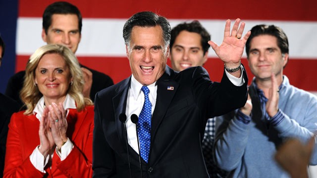 PHOTO: Republican presidential hopeful Mitt Romney waves to his supporters during his caucus night rally following republican caucuses in Des Moines, Iowa, Jan. 3, 2012.