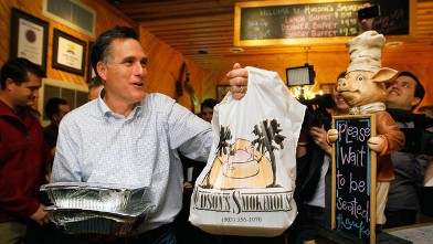 PHOTO: Republican presidential candidate, former Massachusetts Gov. Mitt Romney carries a takeout order of barbeque at Hudson's Smokehouse on January 18, 2012 in Lexington, South Carolina.