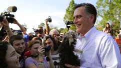 PHOTO: Mitt Romney holds a small dog handed over by a supporter after speaking at a "Florida housing event" in Lehigh, Florida.