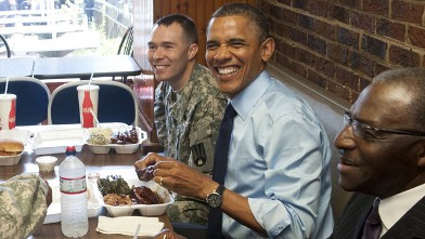 PHOTO: US President Barack Obama eats lunch with two soldiers and two local barbers, in honor of the upcoming Father's Day weekend, at Kenny's BBQ Smokehouse in Washington, DC, June 13, 2012.