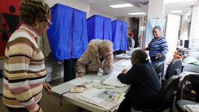 PHOTO: A voter signs in at her polling place inside the Concerned Black Men's Office on Nov. 6, 2012 in North Philadelphia, Pa.