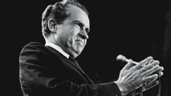 PHOTO: American President Richard Nixon holds his hands together before him around a microphone as he grins during a campaign rally at Madison Square Garden, New York, Oct. 31, 1968.