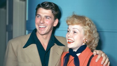 PHOTO: Ronald Reagan (1911-2004), wearing a beige jacket with dark blue shirt with a wide collar, and his wife, Jane Wyman (1917-2007), U.S. actress, wearing a red coat with a dark blue neckscarf and black leather gloves, both smiling, circa 1945.