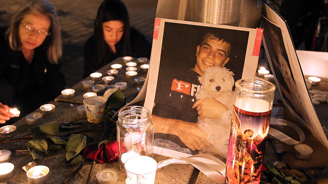 PHOTO: A photograph sits on a memorial for Scott Olsen.