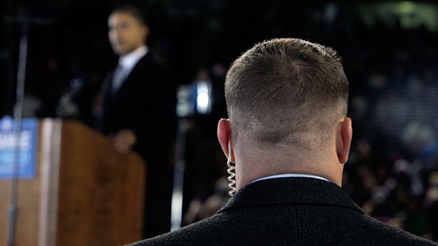 PHOTO: A Secret Service agent stands near then presidential candidate Barack Obama, background, at a rally in this file photo.