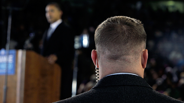PHOTO: A Secret Service agent stands near then presidential candidate Barack Obama, background, at a rally in this file photo.